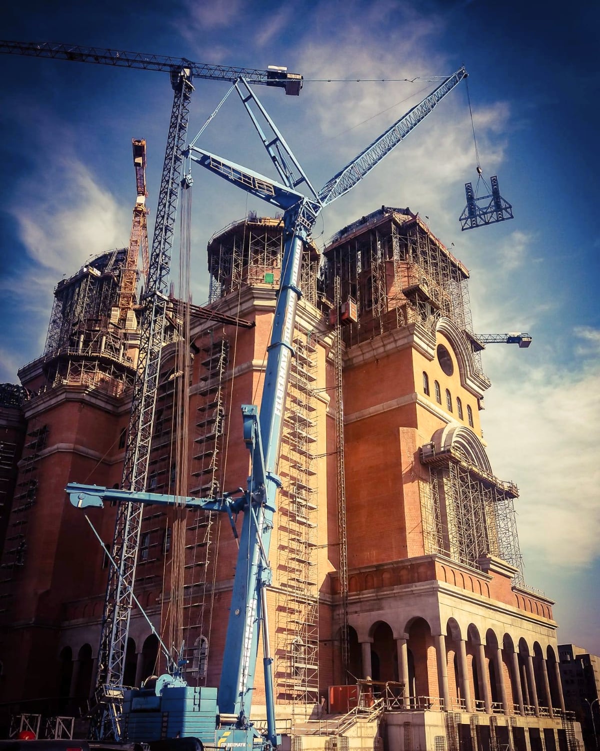 Tower crane rising against the sky above an active CRV Management project