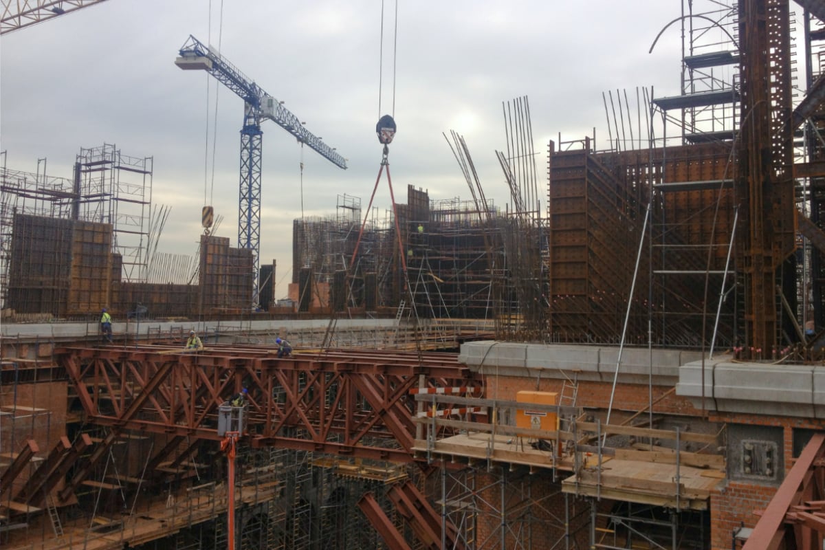 An active construction site with workers and a tower crane